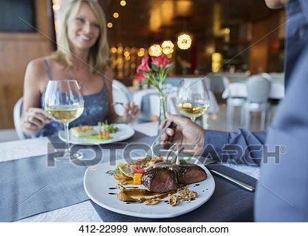 Couple eating dinner in restaurant View Large Photo Image Stock Photo - Couple eating dinner in restaurant. Fotosearch