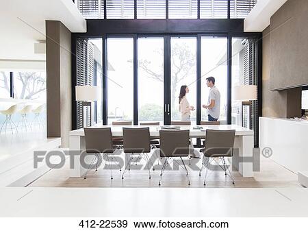 Couple talking in modern dining room View Large Photo Image Stock Photo - Couple talking in modern dining room. Fotosearch