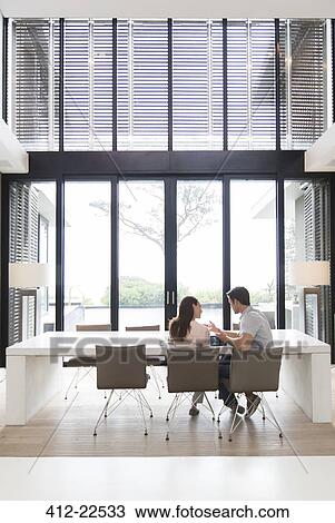 Couple using tablet pc in dining room View Large Photo Image Stock Image - Couple using tablet pc in dining room. Fotosearch