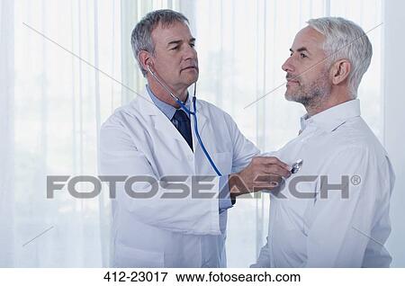 Stock Photo - Doctor examining mature man with stethoscope. Fotosearch