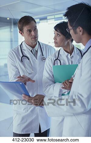 Doctors discussing patient's treatment View Large Photo Image Stock Image - Doctors discussing patient's treatment. Fotosearch
