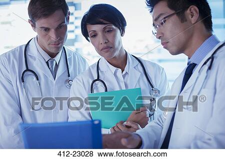 Doctors discussing patient's treatment View Large Photo Image Stock Photo - Doctors discussing patient's treatment. Fotosearch