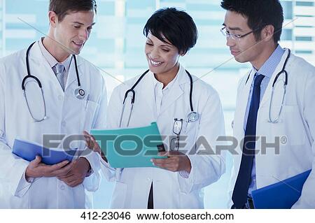 Doctors discussing patient's treatment View Large Photo Image Stock Photograph - Doctors discussing patient's treatment. Fotosearch