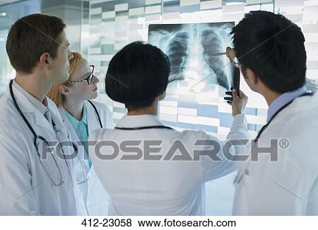 Stock Photo - Doctors looking at patient's x-ray. Fotosearch