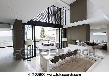 Stock Image - Elevated view of spacious dining room with patio. Fotosearch