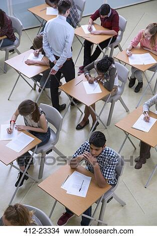 Elevated view of students writing their GCSE exam View Large Photo Image Picture - Elevated view of students writing their GCSE exam. Fotosearch