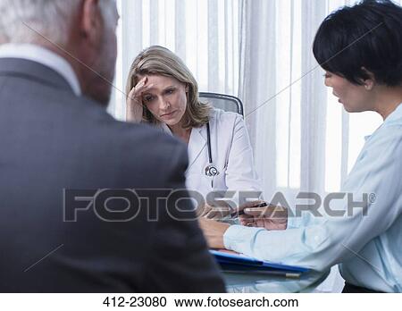 Female doctor, man and woman talking at table in conference room View Large Photo Image Stock Image - Female doctor, man and woman talking at table in conference room. Fotosearch