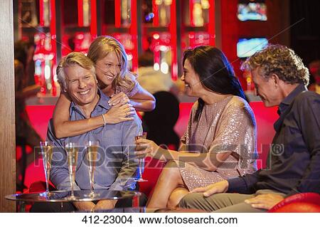 Picture - Friends enjoying themselves in nightclub. Fotosearch