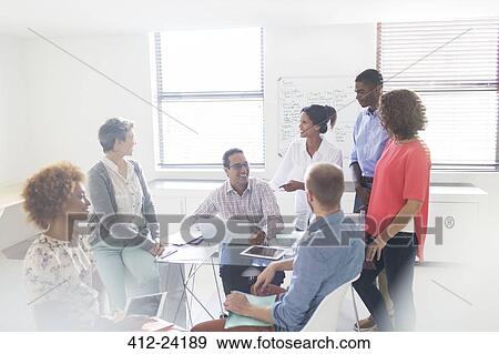 Stock Photo - Group of business people having meeting in modern office. Fotosearch