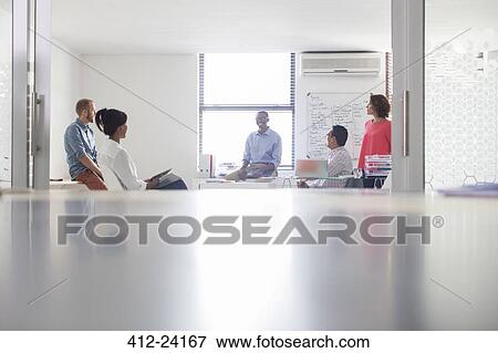 Stock Photo - Group of business people working in white modern office. Fotosearch