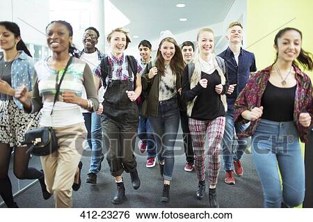 Group of cheerful students running in corridor View Large Photo Image Stock Photograph - Group of cheerful students running in corridor. Fotosearch