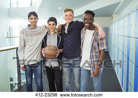 Group portrait of male students holding basketball in school corridor View Large Photo Image Stock Photo - Group portrait of male students holding basketball in school corridor. Fotosearch