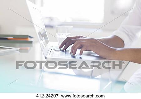 Stock Photo - Hands of businesswoman typing on laptop in office. Fotosearch