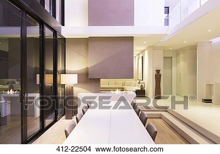Picture - Large table in modern dining room during night . Fotosearch