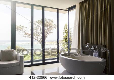 Stock Photograph - Luxurious bathroom with beautiful view on coast. Fotosearch