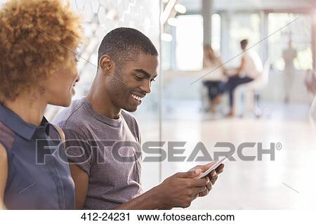 Man and woman using digital tablet in office, colleagues in background View Large Photo Image Stock Image - Man and woman using digital tablet in office, colleagues in background. Fotosearch