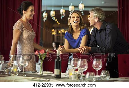 Man and women smiling at talking in elegant restaurant View Large Photo Image Stock Photography - Man and women smiling at talking in elegant restaurant. Fotosearch