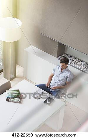 Man using tablet pc in modern dining room View Large Photo Image Stock Image - Man using tablet pc in modern dining room. Fotosearch