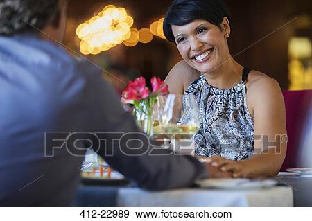 Mature couple holding hands at restaurant table View Large Photo Image Stock Photo - Mature couple holding hands at restaurant table. Fotosearch