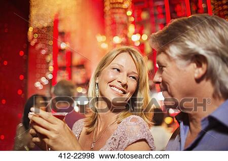 Stock Photo - Mature couple smiling in nightclub. Fotosearch