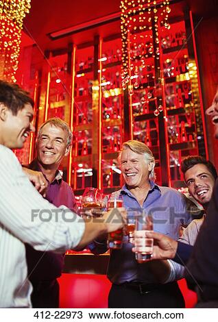 Men enjoying themselves at party View Large Photo Image Stock Image - Men enjoying themselves at party. Fotosearch