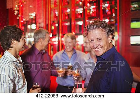 Men enjoying themselves at party View Large Photo Image Stock Photo - Men enjoying themselves at party. Fotosearch
