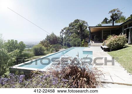 Modern house exterior with large swimming pool View Large Photo Image Stock Photo - Modern house exterior with large swimming pool. Fotosearch