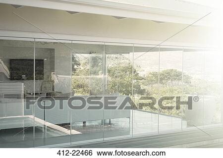Modern house interior seen from outside View Large Photo Image Stock Photograph - Modern house interior seen from outside. Fotosearch