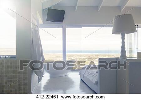 Modern white bedroom interior with bed large bathtub View Large Photo Image Stock Image - Modern white bedroom interior with bed large bathtub. Fotosearch