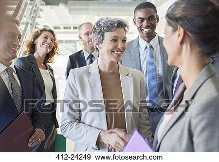 Stock Photo - Office team congratulating businesswoman. Fotosearch