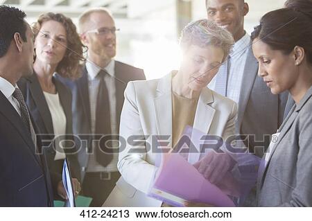 Office team sharing documents at meeting View Large Photo Image Stock Image - Office team sharing documents at meeting . Fotosearch