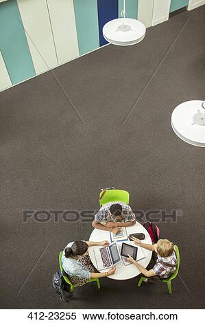 Overhead view of student doing homework, using laptop and digital tablet View Large Photo Image Stock Photography - Overhead view of student doing homework, using laptop and digital tablet. Fotosearch