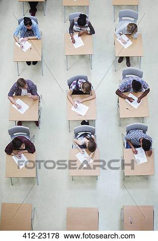 Overhead view of students writing their GCSE examination View Large Photo Image Stock Photo - Overhead view of students writing their GCSE examination. Fotosearch