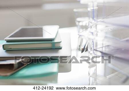 Stock Image - Paper materials and digital tablet on desk in office. Fotosearch