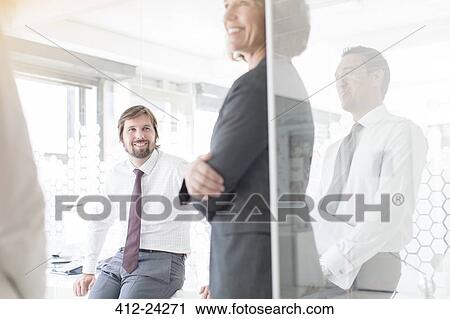 Stock Image - People having meeting in modern office. Fotosearch