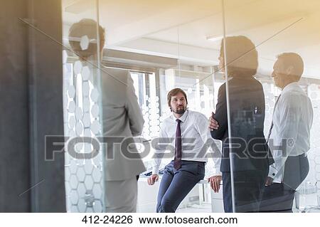 People having meeting in modern office seen through glass door View Large Photo Image Stock Photograph - People having meeting in modern office seen through glass door. Fotosearch