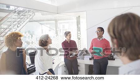 Stock Photo - People having meeting in office. Fotosearch