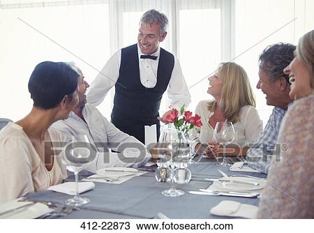 People sitting at restaurant table and talking to waiter View Large Photo Image Stock Image - People sitting at restaurant table and talking to waiter. Fotosearch