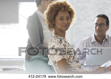 Portrait of businesswoman in office, colleagues in background View Large Photo Image Stock Photo - Portrait of businesswoman in office, colleagues in background. Fotosearch