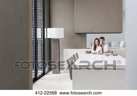 Portrait of couple with tablet pc in dining room View Large Photo Image Stock Photo - Portrait of couple with tablet pc in dining room. Fotosearch