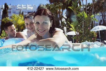 Portrait of family with son in swimming pool View Large Photo Image Stock Photo - Portrait of family with son in swimming pool. Fotosearch