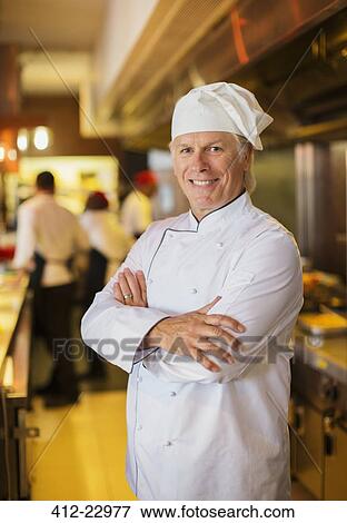 Stock Photo - Portrait of smiling chef in restaurant kitchen. Fotosearch