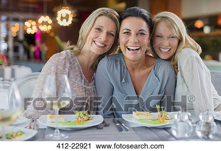 Portrait of smiling women in restaurant View Large Photo Image Stock Image - Portrait of smiling women in restaurant. Fotosearch