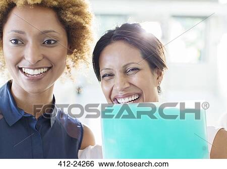 Portrait of two businesswomen laughing View Large Photo Image Stock Photograph - Portrait of two businesswomen laughing. Fotosearch
