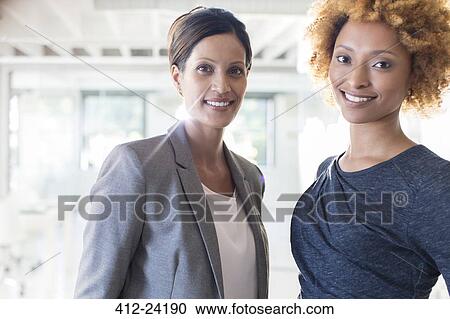 Portrait of two smiling businesswomen in office View Large Photo Image Stock Image - Portrait of two smiling businesswomen in office. Fotosearch