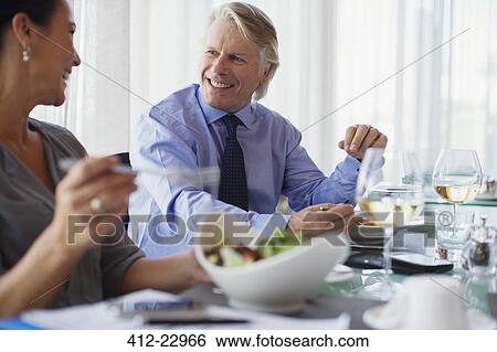 Smiling business people having lunch in restaurant View Large Photo Image Stock Photograph - Smiling business people having lunch in restaurant. Fotosearch