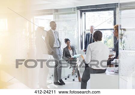 Smiling business people having meeting in modern in office View Large Photo Image Stock Image - Smiling business people having meeting in modern in office. Fotosearch