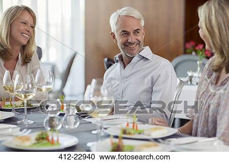 Smiling people enjoying their meal in restaurant View Large Photo Image Stock Image - Smiling people enjoying their meal in restaurant. Fotosearch