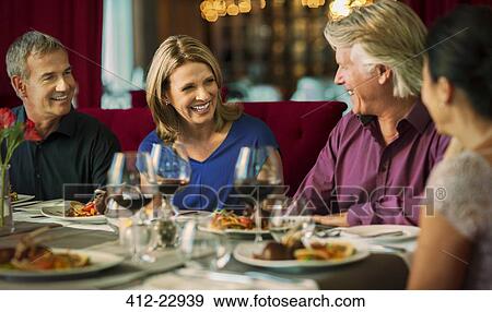 Smiling people enjoying their meal in restaurant View Large Photo Image Stock Photo - Smiling people enjoying their meal in restaurant. Fotosearch