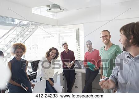 Smiling team having meeting in modern office View Large Photo Image Stock Image - Smiling team having meeting in modern office. Fotosearch